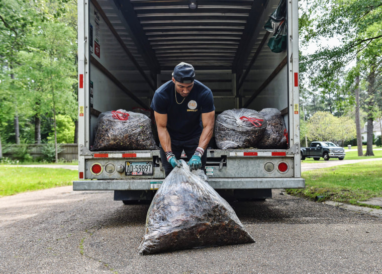 Alexander Shaw of T&C Movers loads garbage into a U-Haul truck in Jackson, Miss., on April 5, 2023.Syndication: The Clarion-Ledger