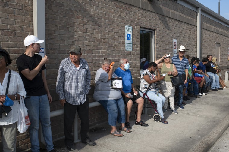 People wait in line at a Social Security office in Houston