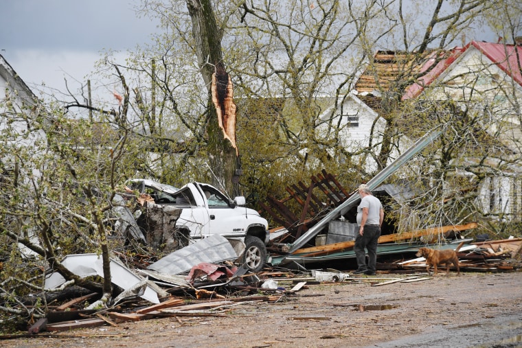 A man surveys the debris outside his destroyed home on April 5, 2023 in Glenallen, Mo.