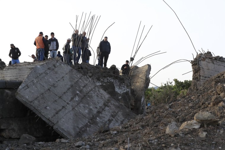 Locals check a small bridge that was destroyed by an Israeli airstrike, in Maaliya village, Lebanon, on April 7, 2023.