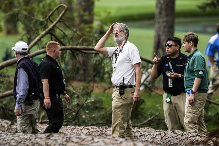 Image: Authorities investigate the scene where trees fell on the 17th hole during the second round of the Masters golf tournament at Augusta National Golf Club