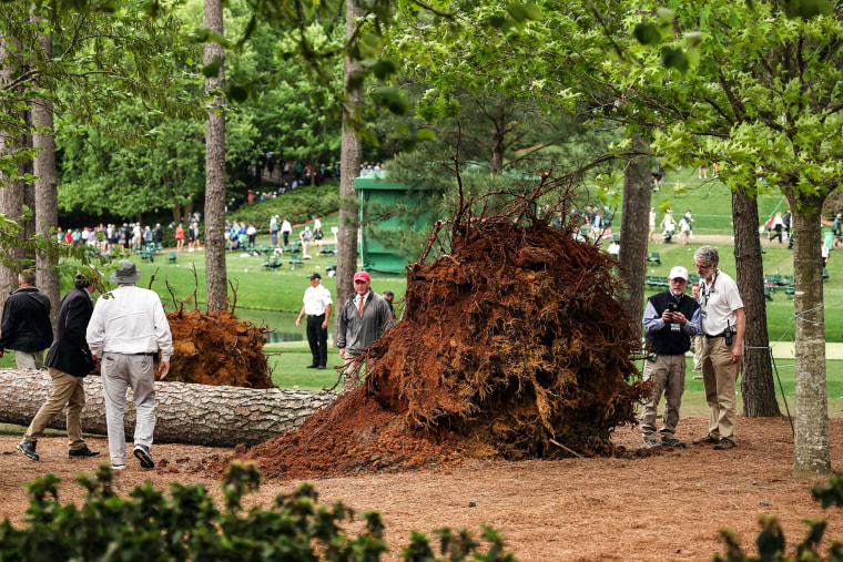 Image: Course officials look over fallen trees on the 17th hole during the second round of the 2023 Masters Tournament