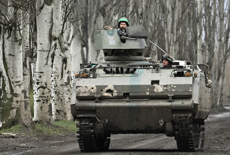 Ukrainian servicemen on a road near Bakhmut, Donetsk region, on April 6, 2023.