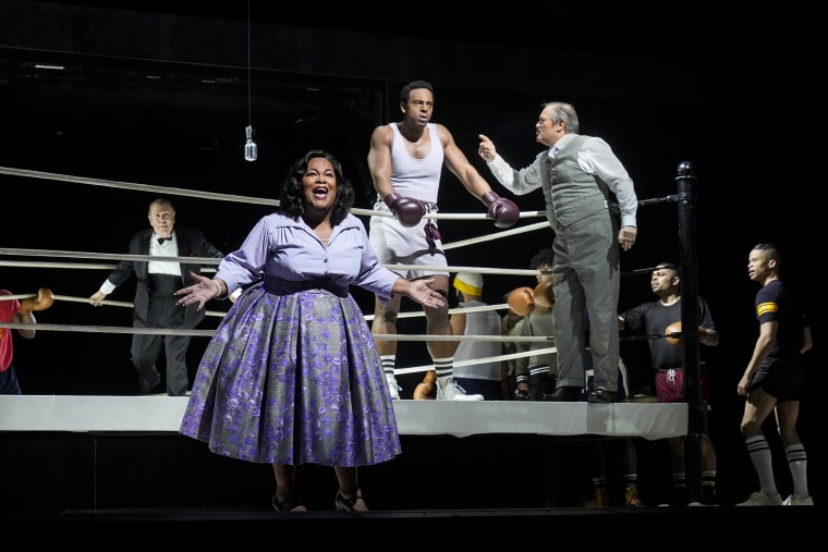 Lee Wilkof, left, as the ring announcer, Latonia Moore as Emelda Griffith, Ryan Speedo Green as young Emile Griffith, and Paul Groves as Howie Albert in Terence Blanchard's "Champion." 
