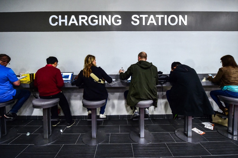 Attendees use a charging station for their mobile devices at the 2017 Consumer Electronic Show in Las Vegas.