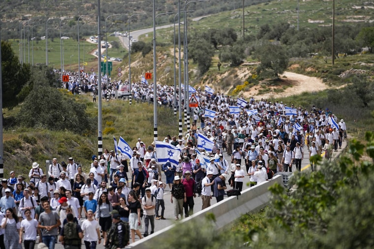 People march to Eviatar in the occupied West Bank territory on April 10, 2023.
