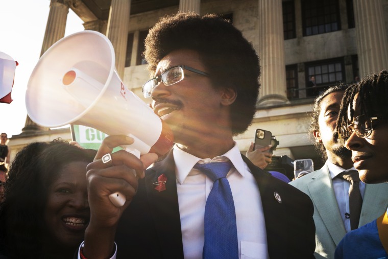 Expelled State Rep. Justin Pearson delivers remarks through a megaphone outside the Tennessee Capitol in Nashville