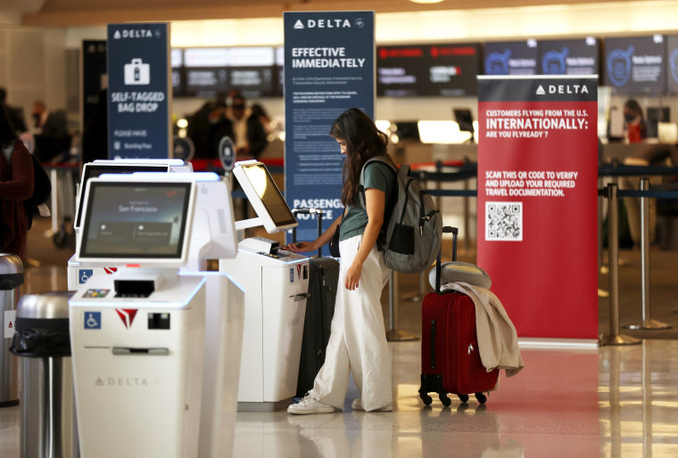 A Delta Airlines customer checks in for a flight at a kiosk at the San Francisco International Airport in San Francisco