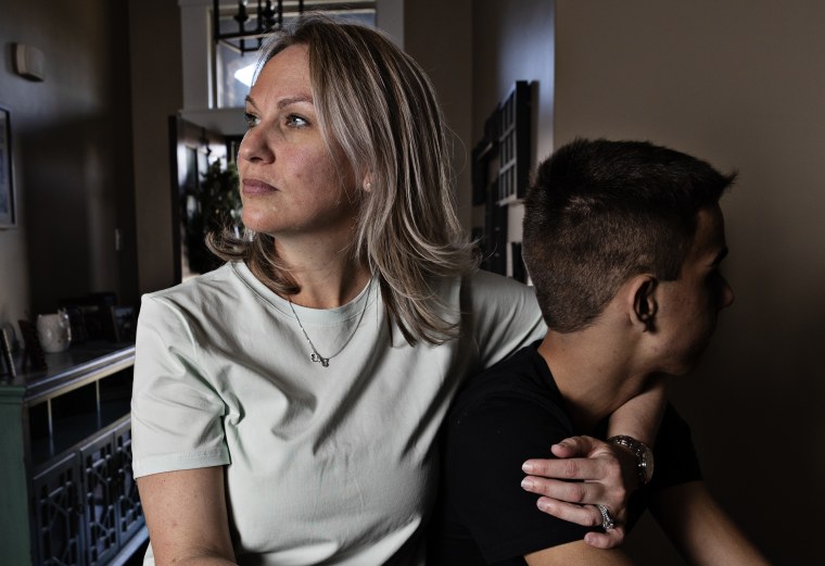 Heather McConney holds her son at their home in Layton, Utah