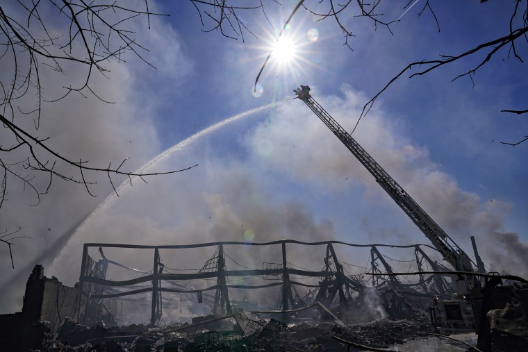 Firefighters spray water on an industrial fire in Richmond, Ind., Thursday, April 13, 2023.