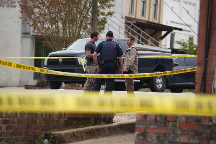 Investigators work at the crime scene following a shooting in Dadeville, Alabama.