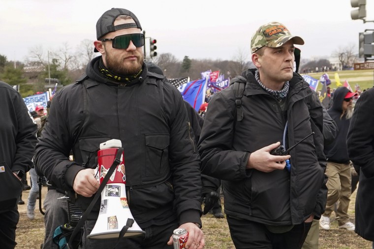 Proud Boys members Ethan Nordean, left, and Zachary Rehl walk toward the U.S. Capitol