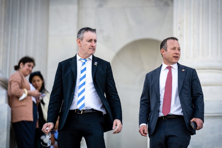 Rep. Brian Fitzpatrick, R-Pa., and Rep. Josh Gottheimer, D-N.J., walk down the House steps of the Capitol on April 28, 2022.
