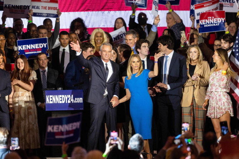 BOSTON, MA - APRIL 19: Robert F. Kennedy Jr. and his wife Actress Cheryl Hines wave to supporters on stage after announcing his candidacy for President on April 19, 2023 in Boston, Massachusetts. An outspoken anti-vaccine activist, RFK Jr. joins self-help author Marianne Williamson in the Democratic presidential field of challengers for 2024. (Photo by Scott Eisen/Getty Images)