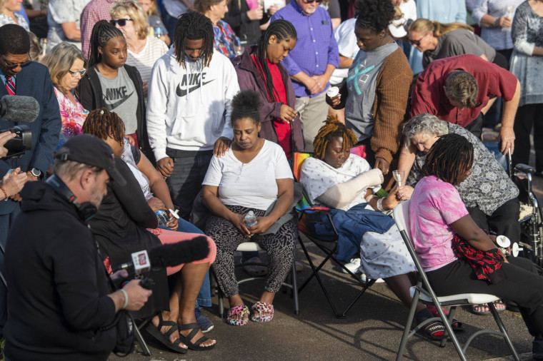 Shooting victim Taniya Cox, wearing a cast, prays with her family during a vigil at First Baptist Church in Dadeville, Ala., on Sunday, April 16, 2023. 