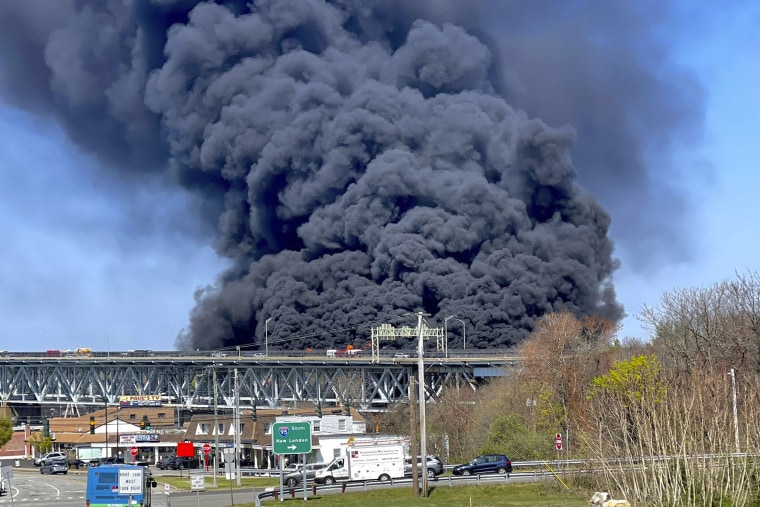 Plumes of smoke rise from a fire resulting from crash on the Gold Star Memorial Bridge in Groton, CT