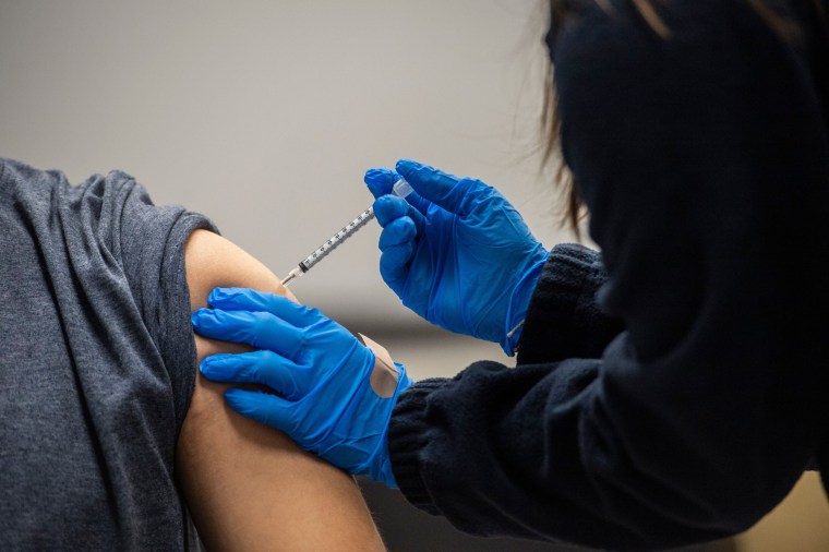 A man receives a Pfizer-BioNTech Covid-19 vaccine in Chelsea, Mass