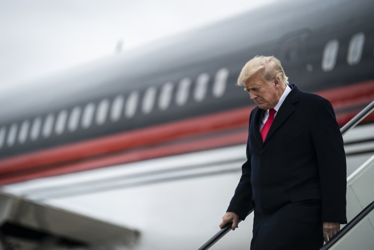 Former President Donald Trump disembarks his plane at the Quad City International Airport in Moline, Ill.