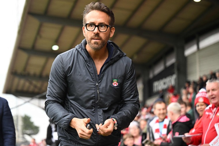 Ryan Reynolds walks pitch-side ahead of the English National League football match in Wrexham, Wales