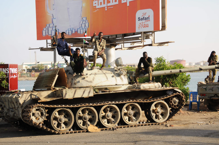 Sudanese army soldier sit atop a tank in the Red Sea city of Port Sudan