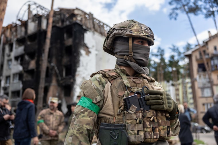 A Ukrainian army soldier stands guard at the war damaged Irpinsky Lipky residential complex in Irpin, Ukraine