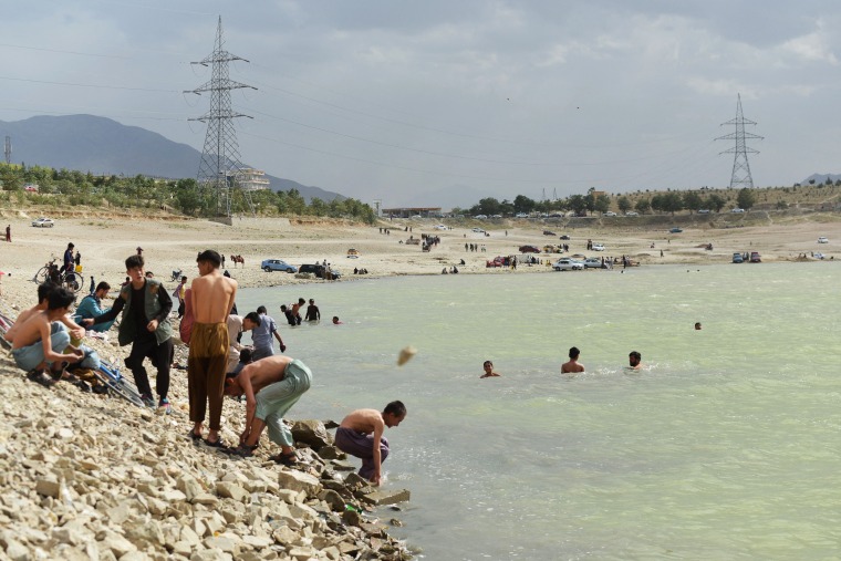People cool off at Qargha Lake during a hot summer day on the outskirts of Kabul, Afghanistan