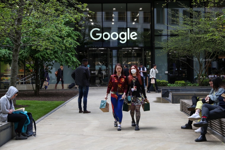 People walk outside Google's offices in London