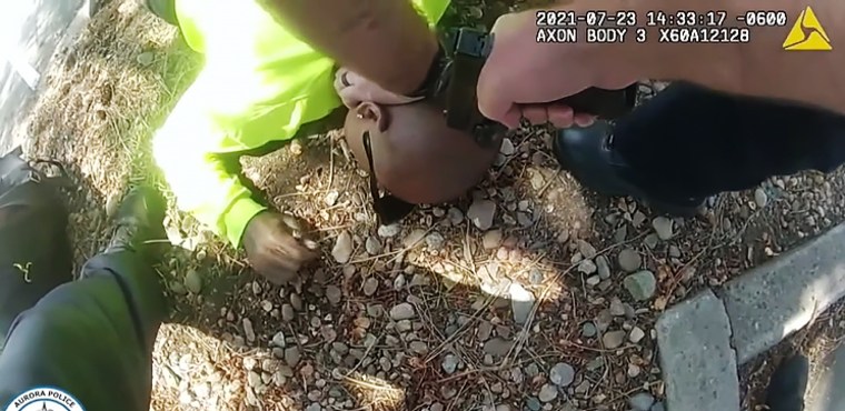 Officer John Haubert holds a gun to Kyle Vinson's head on July 23, 2021, in Aurora, Colo. 