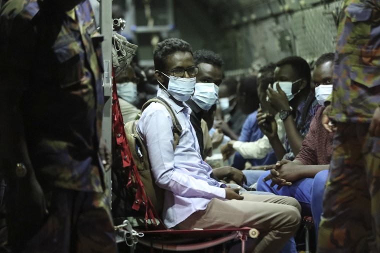 Aboard a Kenya Air Force plane, the first group of Kenyan evacuees from Sudan arrive at Jomo Kenyatta International Airport in Nairobi, Kenya