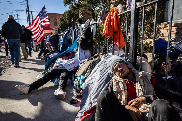 Immigrants gather outside a migrant shelter on Jan. 6, 2023 in El Paso, Texas.