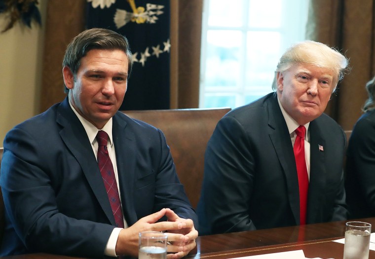 Gov. Ron DeSantis sits next to then-President Donald Trump during a meeting with newly elected governors at the White House