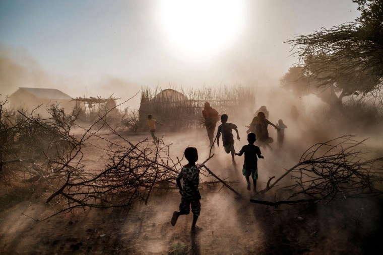Children and women run through a cloud of dust in the village of El Gel, Ethiopia, on Jan. 12, 2023. The last five rainy seasons since the end of 2020 have failed, triggering the worst drought in four decades in Ethiopia, Somalia and Kenya. 