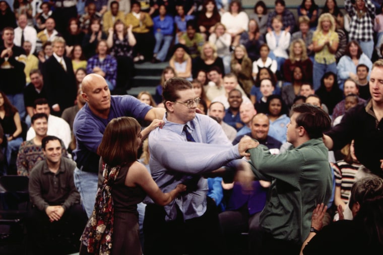 Security guard Steve Wilkos, left, tries to separate fighting guests on The Jerry Springer Show. The show's topic was "I Am Pregnant By Half-Brother." 