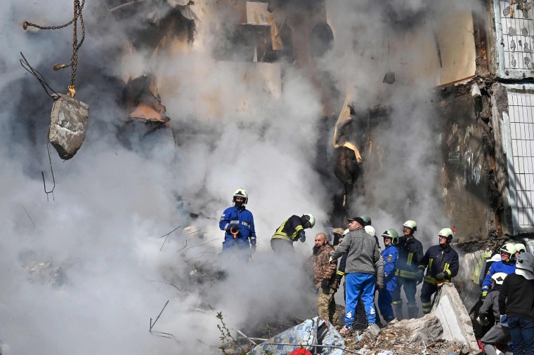 Rescuers search for survivors in the rubble of a damaged residential building in Uman, Ukraine