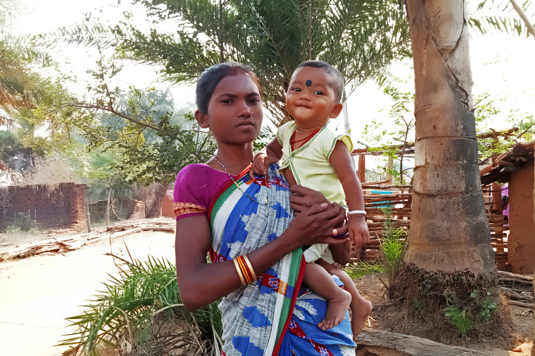 Chandrika holding her 1-year-old boy outside her house in Gadadi, Kalahandi in Odisha, April 18.