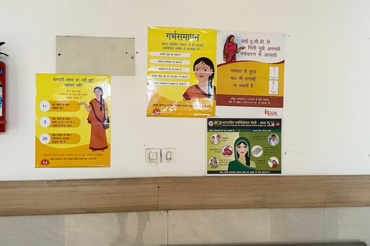 A cluster of posters in Gautam Buddha Nagar District Hospital showcasing a young woman and the family planning services the government provides