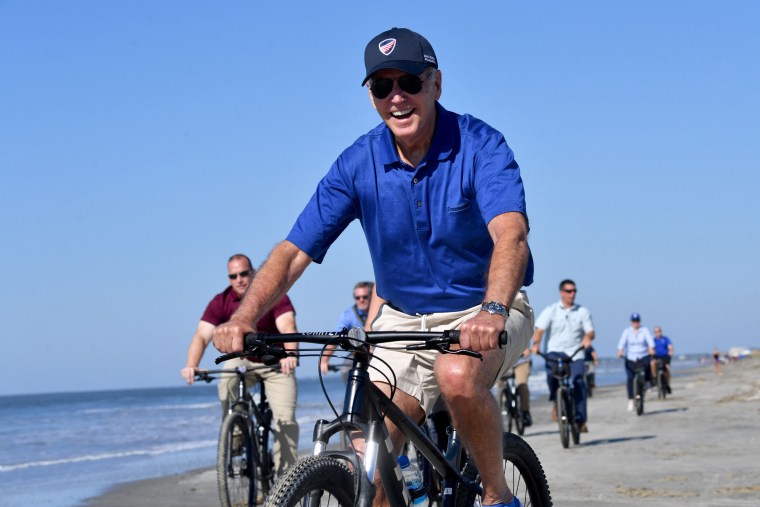 Joe Biden rides his bicycle along the beach in Kiawah Island