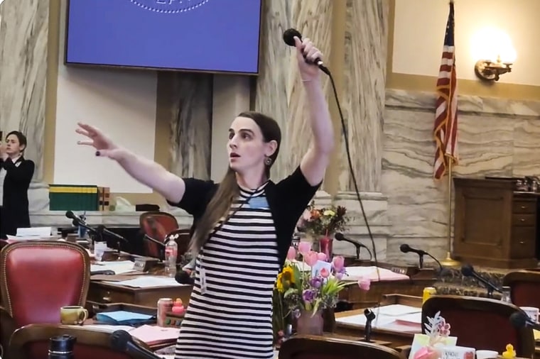 Image: Montana Democratic Rep. Zooey Zephyr hoists a microphone into the air on April 24, 2023, as her supporters interrupt proceedings in the state House by chanting "Let Her Speak!" in Helena, Mont.