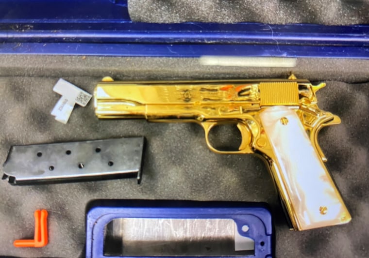 The woman was found with this 24-carat gold-plated handgun in her luggage at Sydney Airport on Sunday.