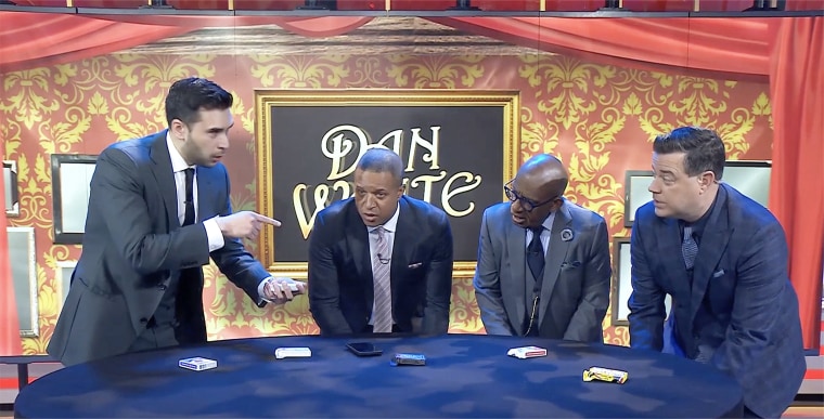 Craig, Al, and Carson pick their cards under the table while Dan White (left) tells them what to do.