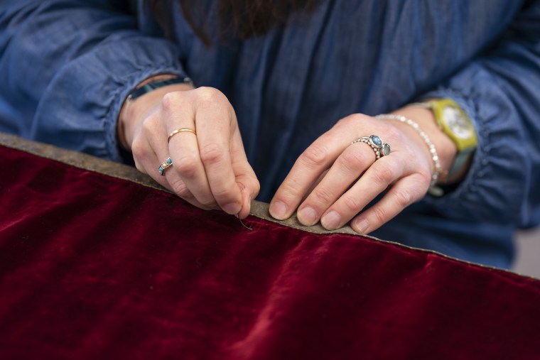 Work is carried out on King Charles III's Robe of State, which he will wear at his coronation on May 6, by a member of the Royal School of Needlework, at Hampton Court Palace, in East Molesey. Picture date: Monday February 27, 2023.