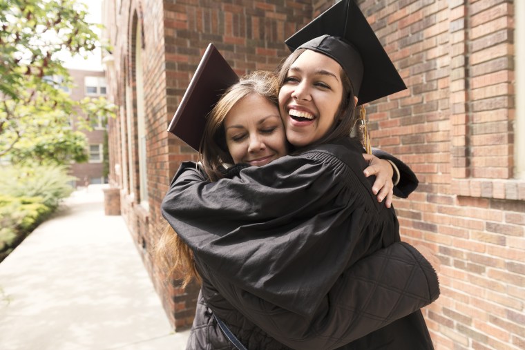 Happy American Mother Hugs Daughter Celebrating Graduation Day USA