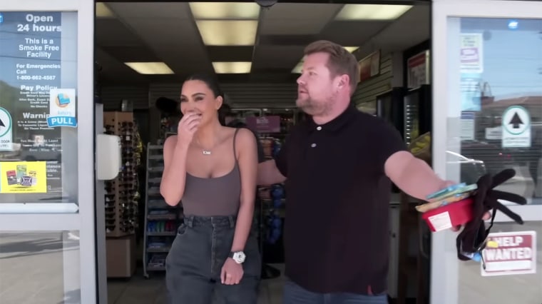 James Corden escorts Kim Kardashian to her after he helped her pick up snacks at the gas station.