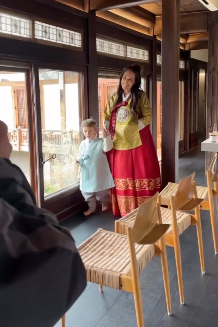 Joanna Gaines and her youngest child, Crew, wearing traditional Korean hanbok.
