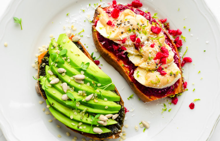 Healthy sandwich of avocado on a sweet potato, and eggs on a sweet potato.