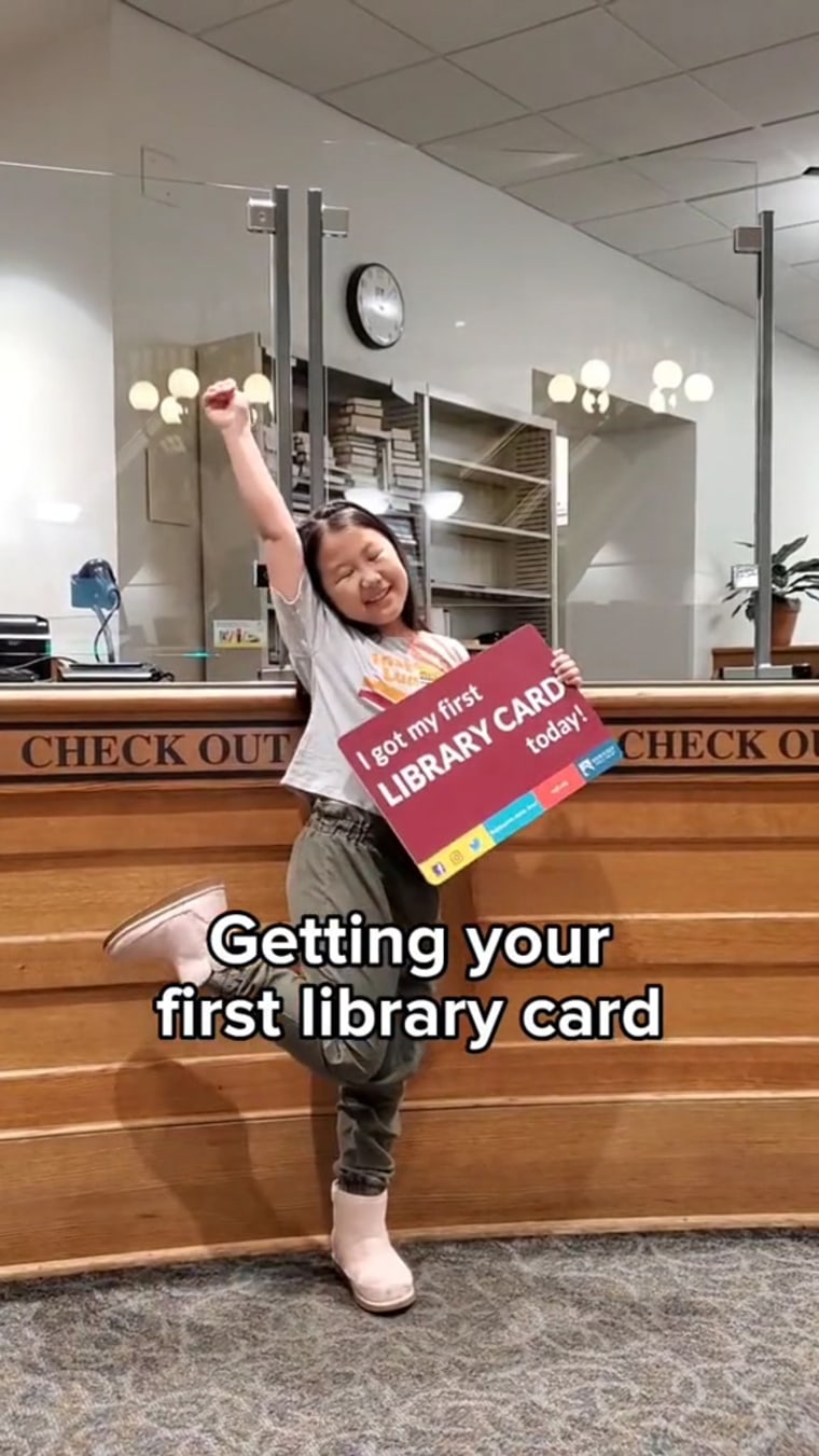 A girl proudly shows off her library card on the Milwaukee Public Library TikTok. 