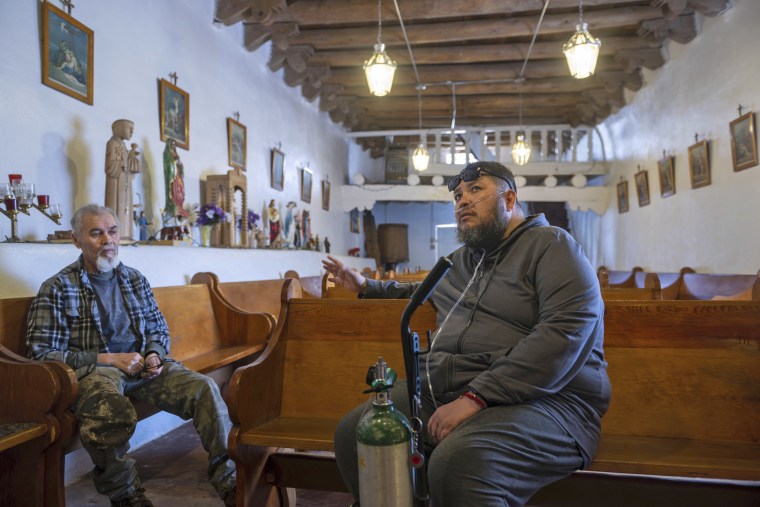 Angelo Sandoval, right, church caretaker, and his uncle, Jerry Sandoval, inside St. Anthony's Catholic church in Cordova.