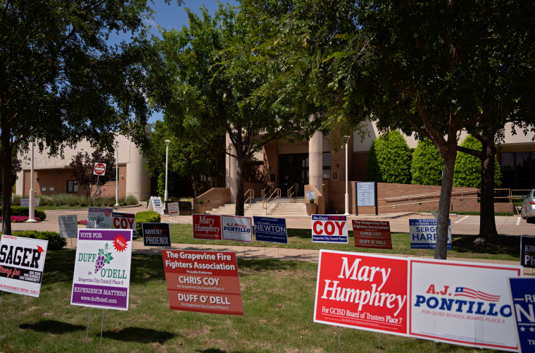 Image: signs of GCISD candidates outside Grapevine Library where people are casting their votes.