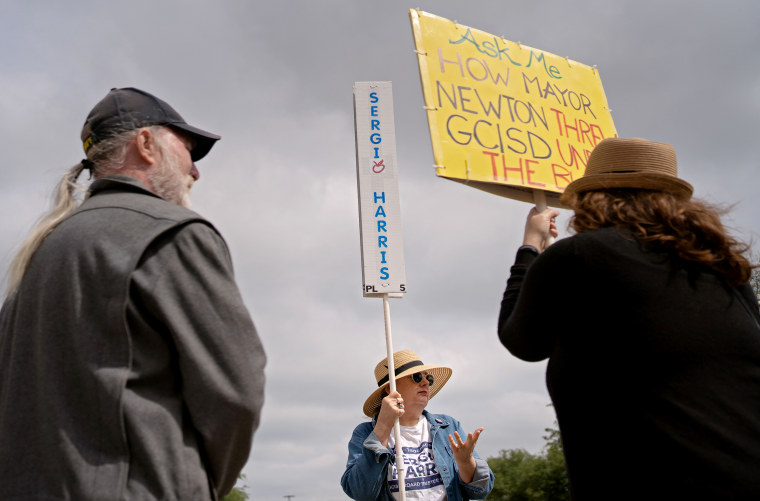 Image: Candidate supporters gather outside of Grapevine Library on Saturday.