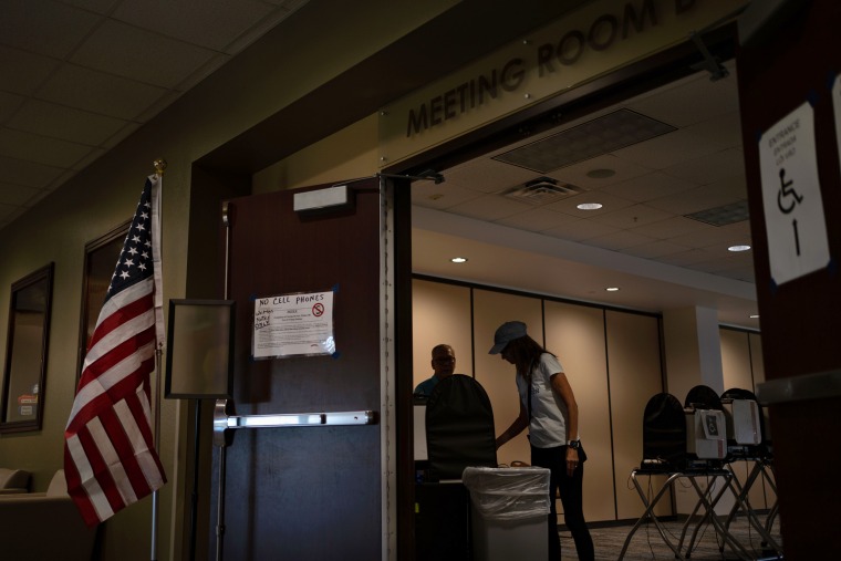 Image: Voters leave after casting ballots for the GCISD school board election at the Colleyville Public Library in Texas on Saturday.